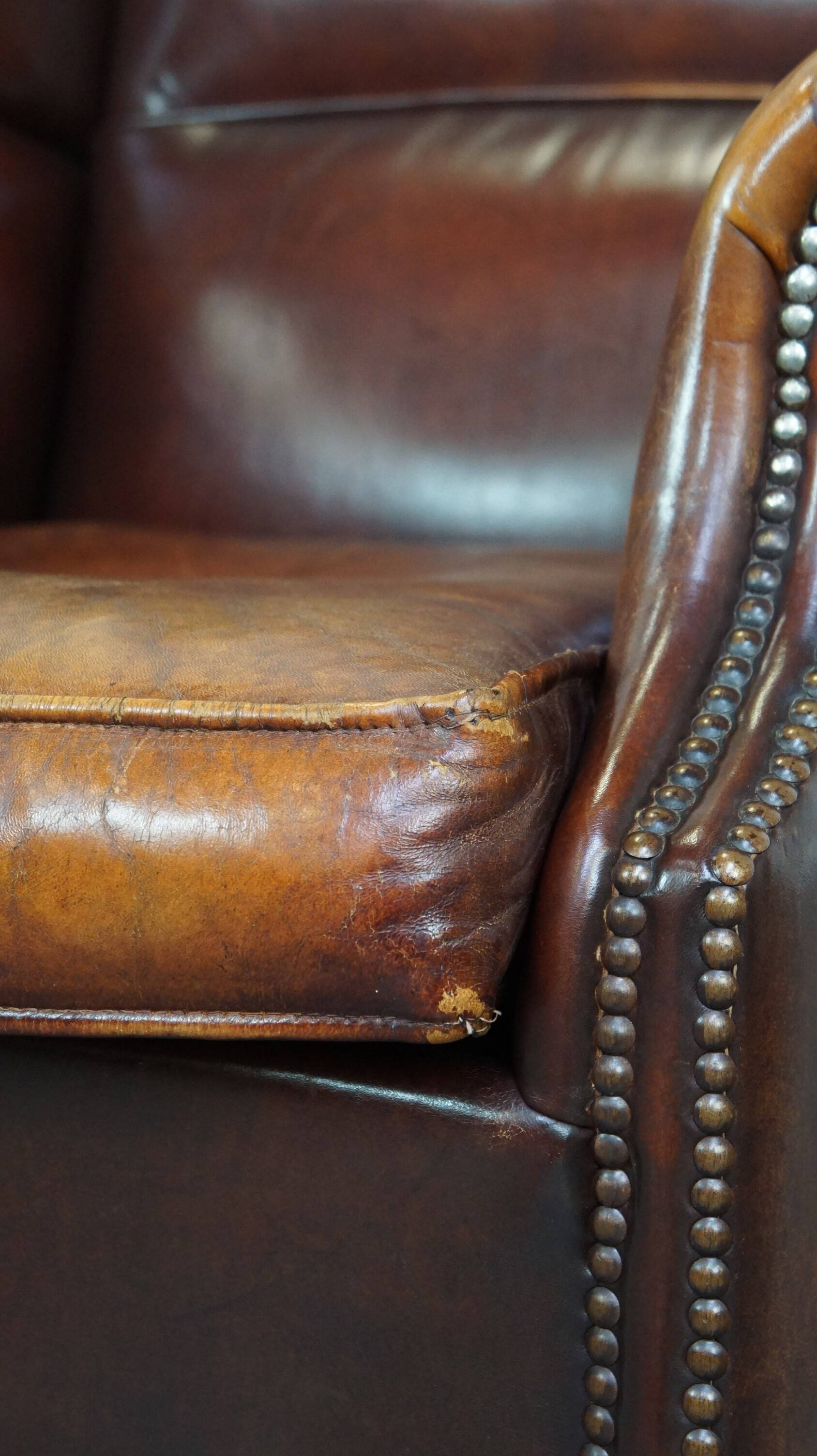 Comfortable, elegant, stately wing chair made of sheepskin in a beautiful warm color