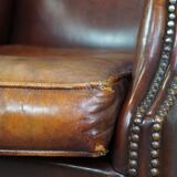 Comfortable, elegant, stately wing chair made of sheepskin in a beautiful warm color