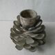 Silver-coloured metal pine cone candlestick