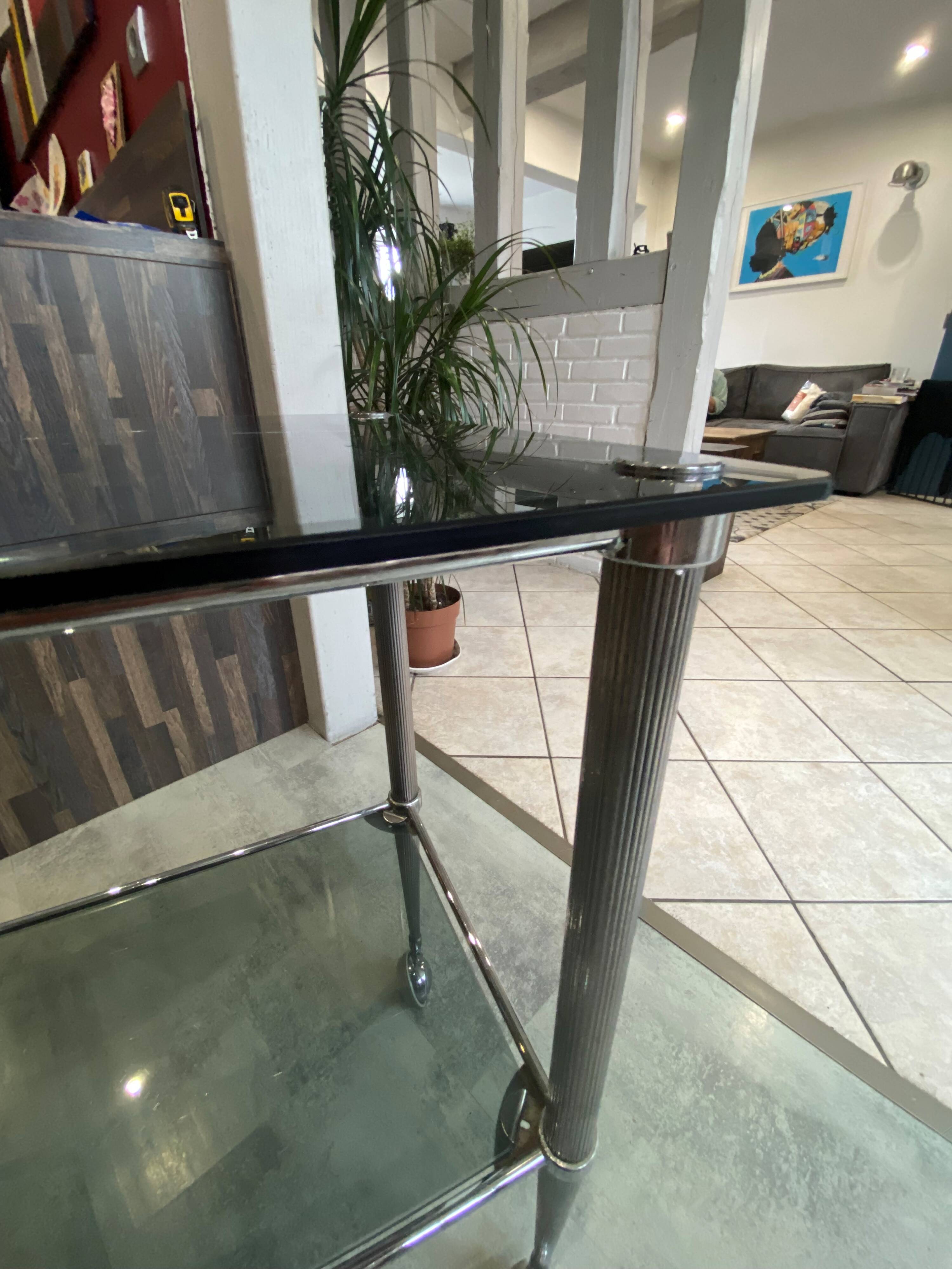 Serving dessert trolley with 2 smoked glass shelves and metal structure.