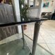 Serving dessert trolley with 2 smoked glass shelves and metal structure.