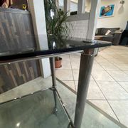 Serving dessert trolley with 2 smoked glass shelves and metal structure.