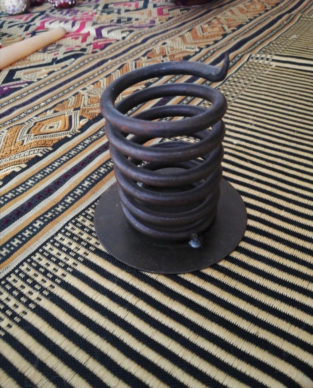 Spiral metal candle holder spring with candle, bronze appearance
