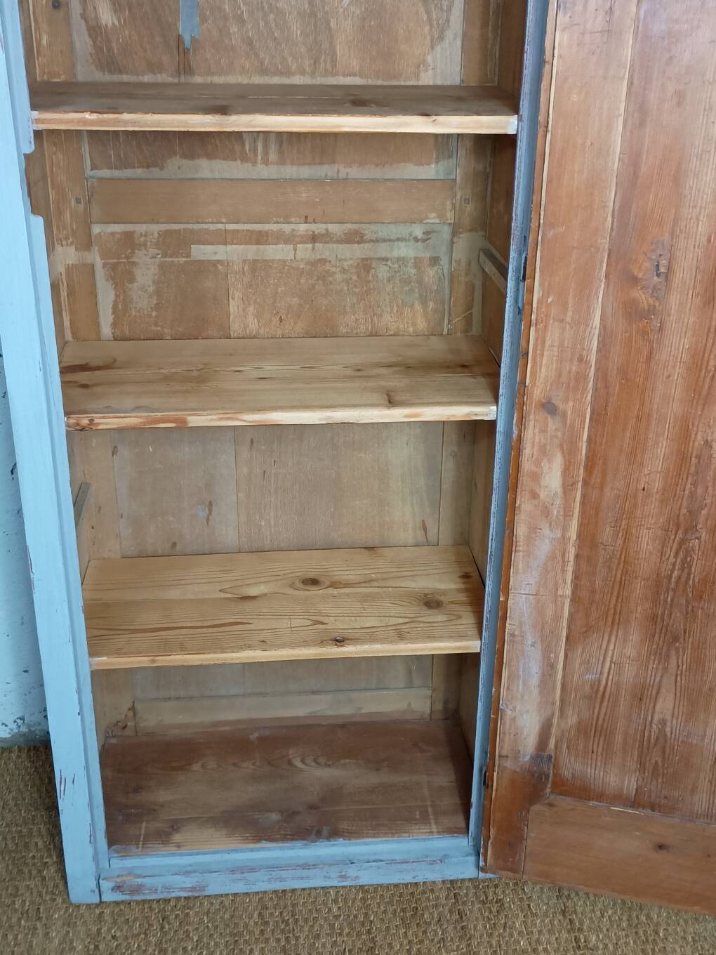 Rustic antique bonnetière in weathered blue-grey wood.