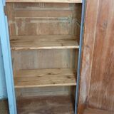 Rustic antique bonnetière in weathered blue-grey wood.