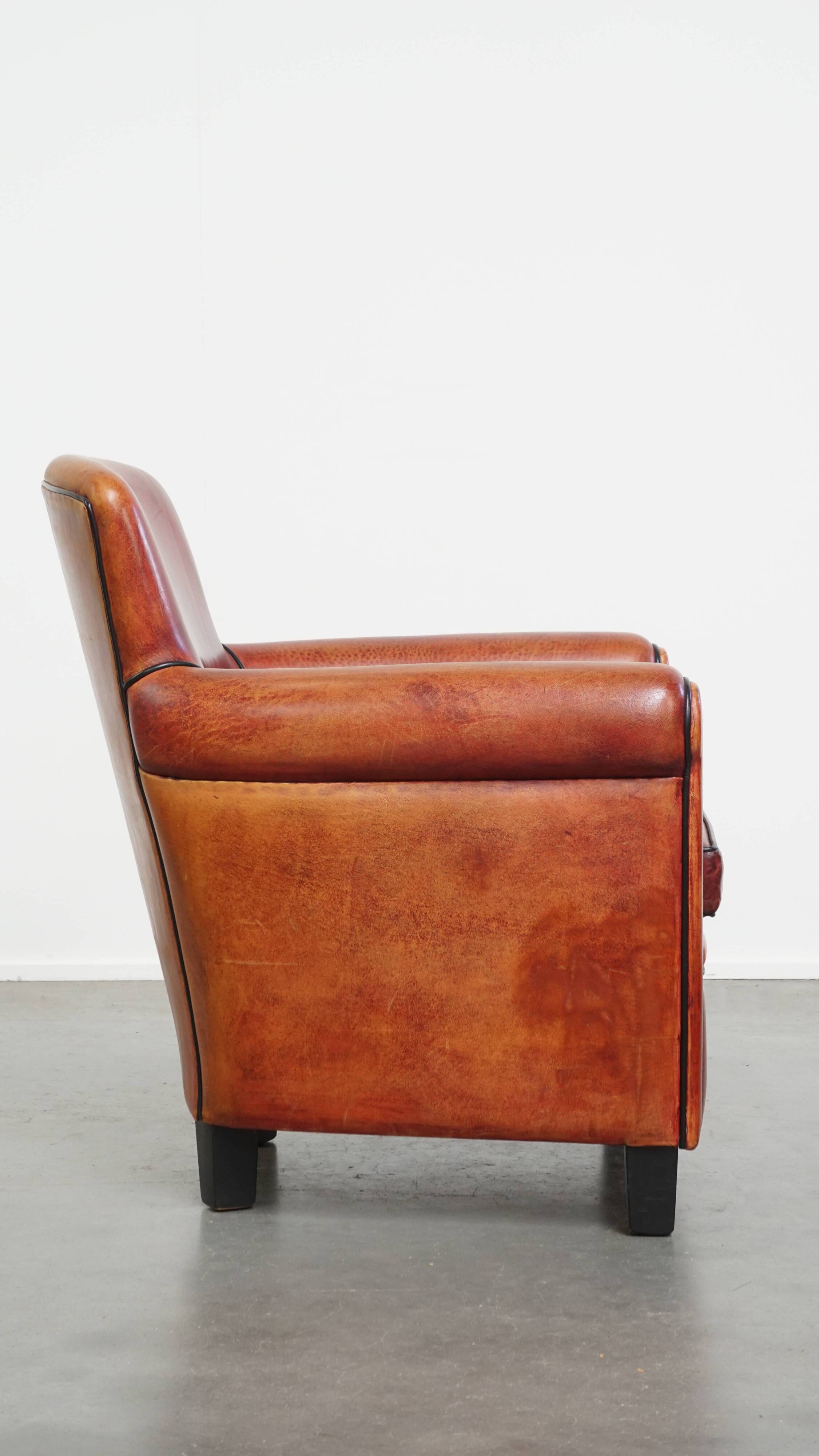 Armchair made of sheepskin leather in a red/brown color