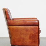 Armchair made of sheepskin leather in a red/brown color