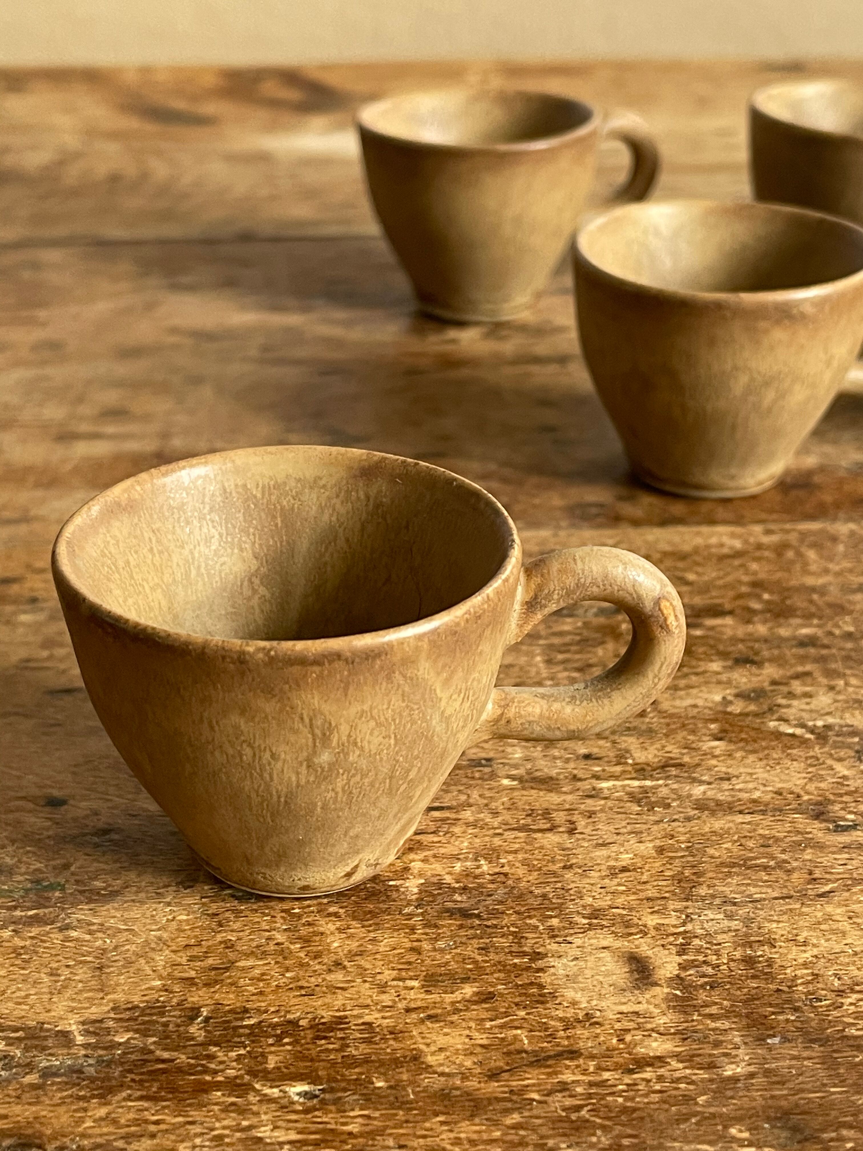 7 very small old sandstone coffee cups