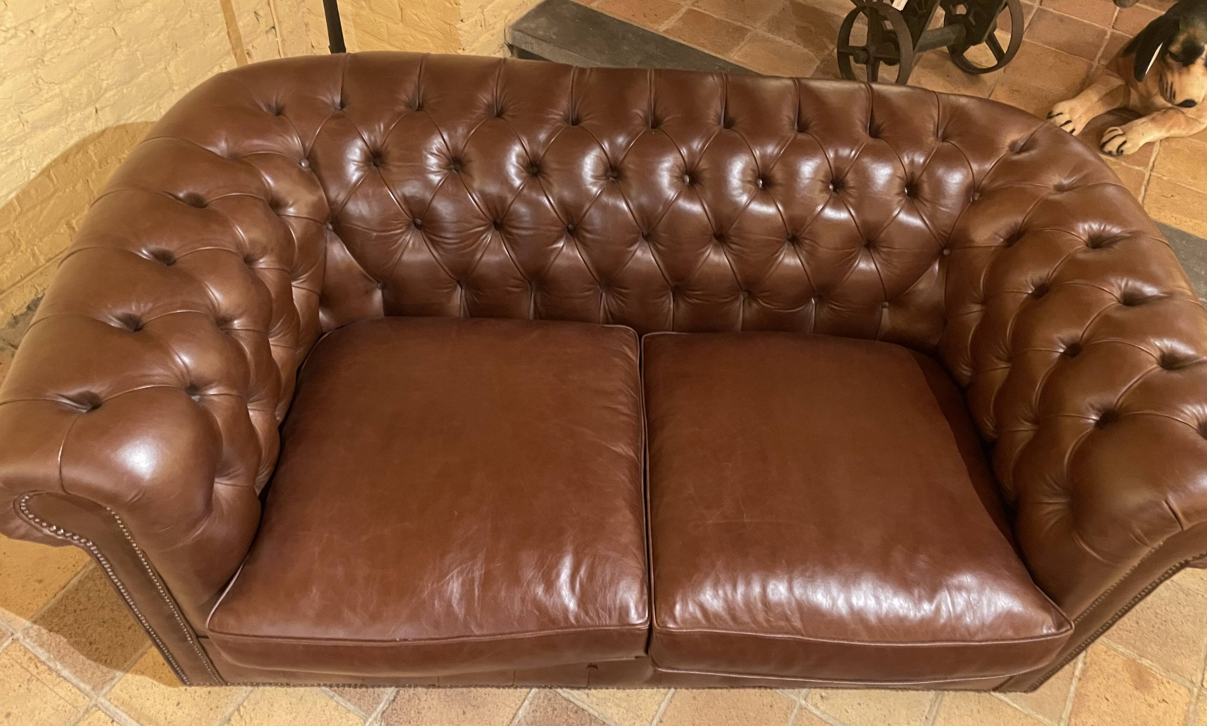 brown leather 2-seater Chesterfield sofa