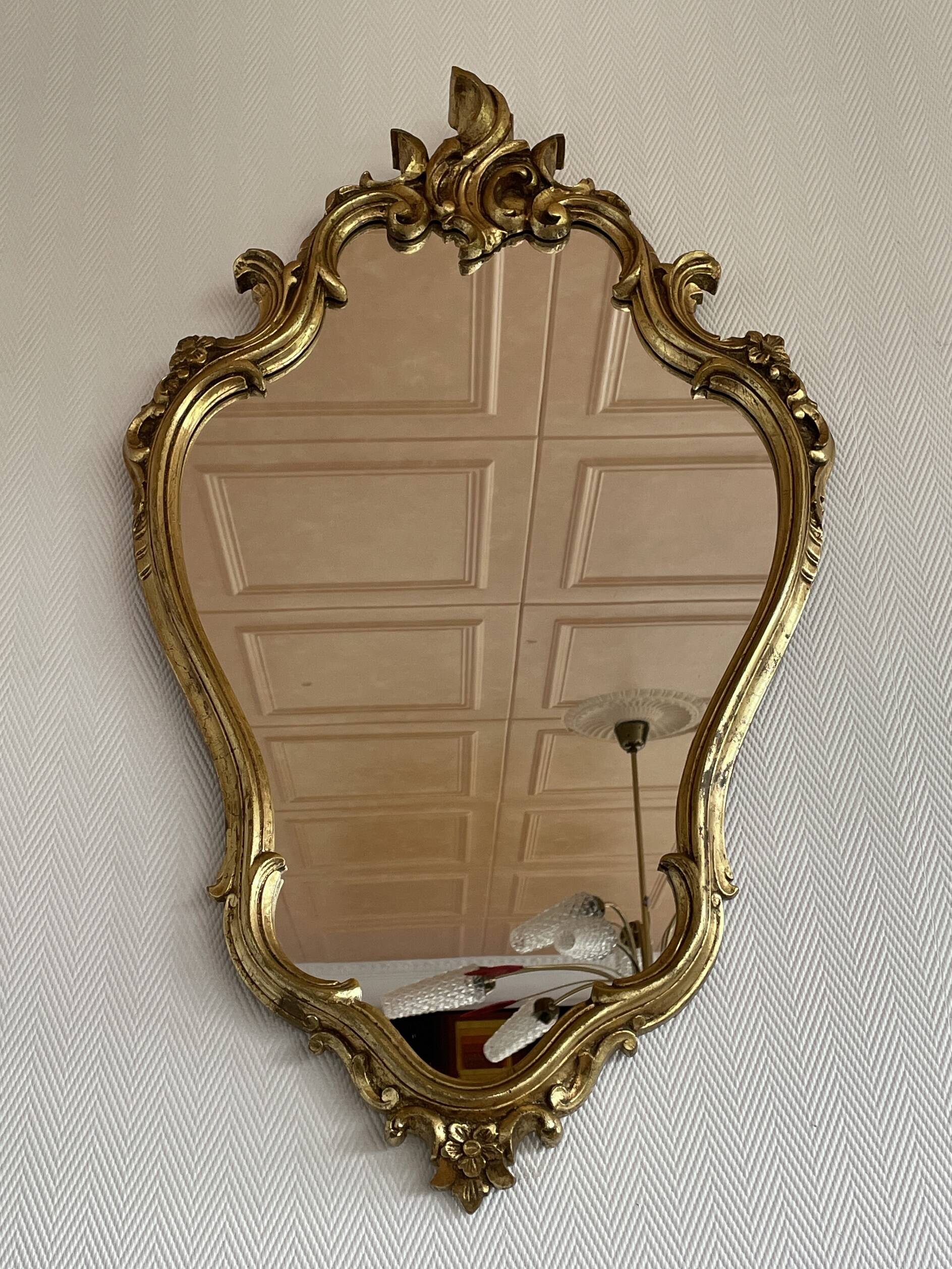 Old baroque style wall mirror with golden moldings