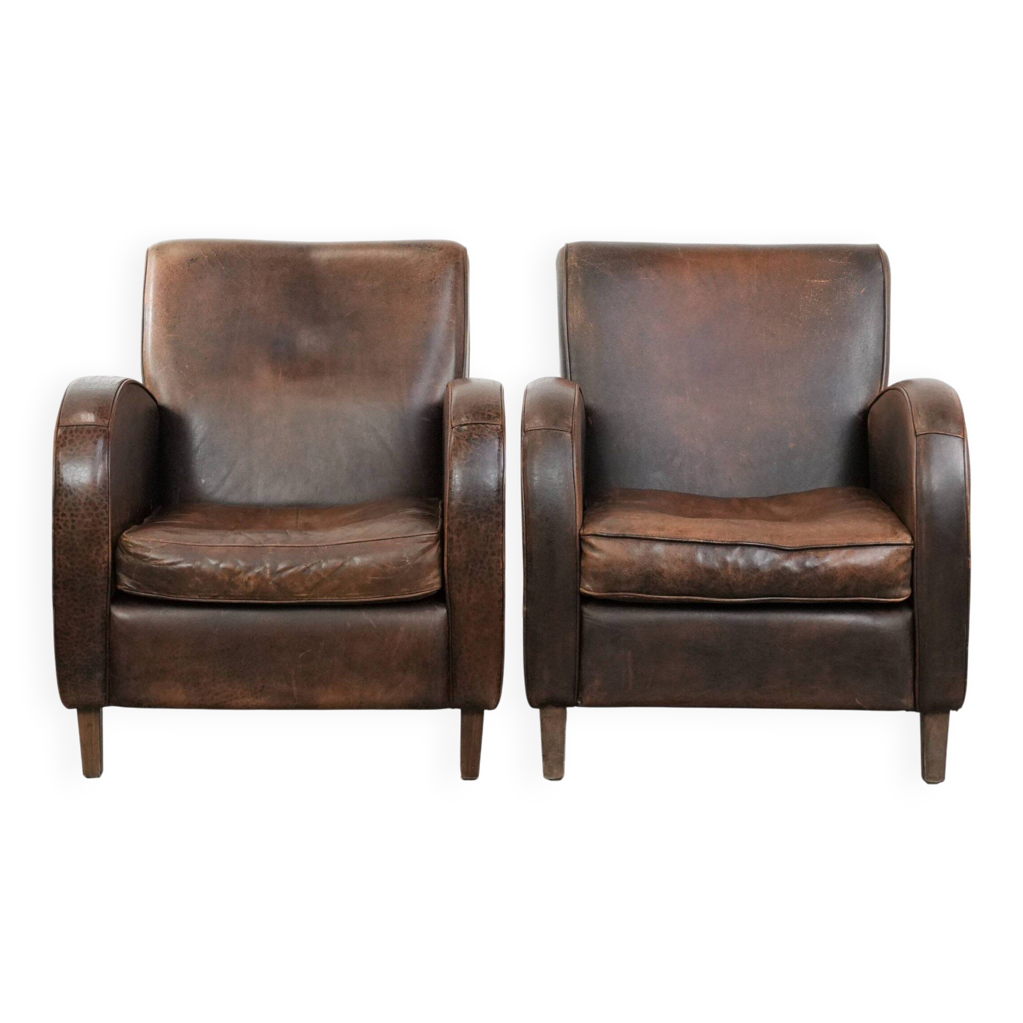 Set of two vintage sheepskin leather design armchairs in a cognac colour