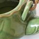 Vintage green teapot with lotus decoration and bamboo handle.