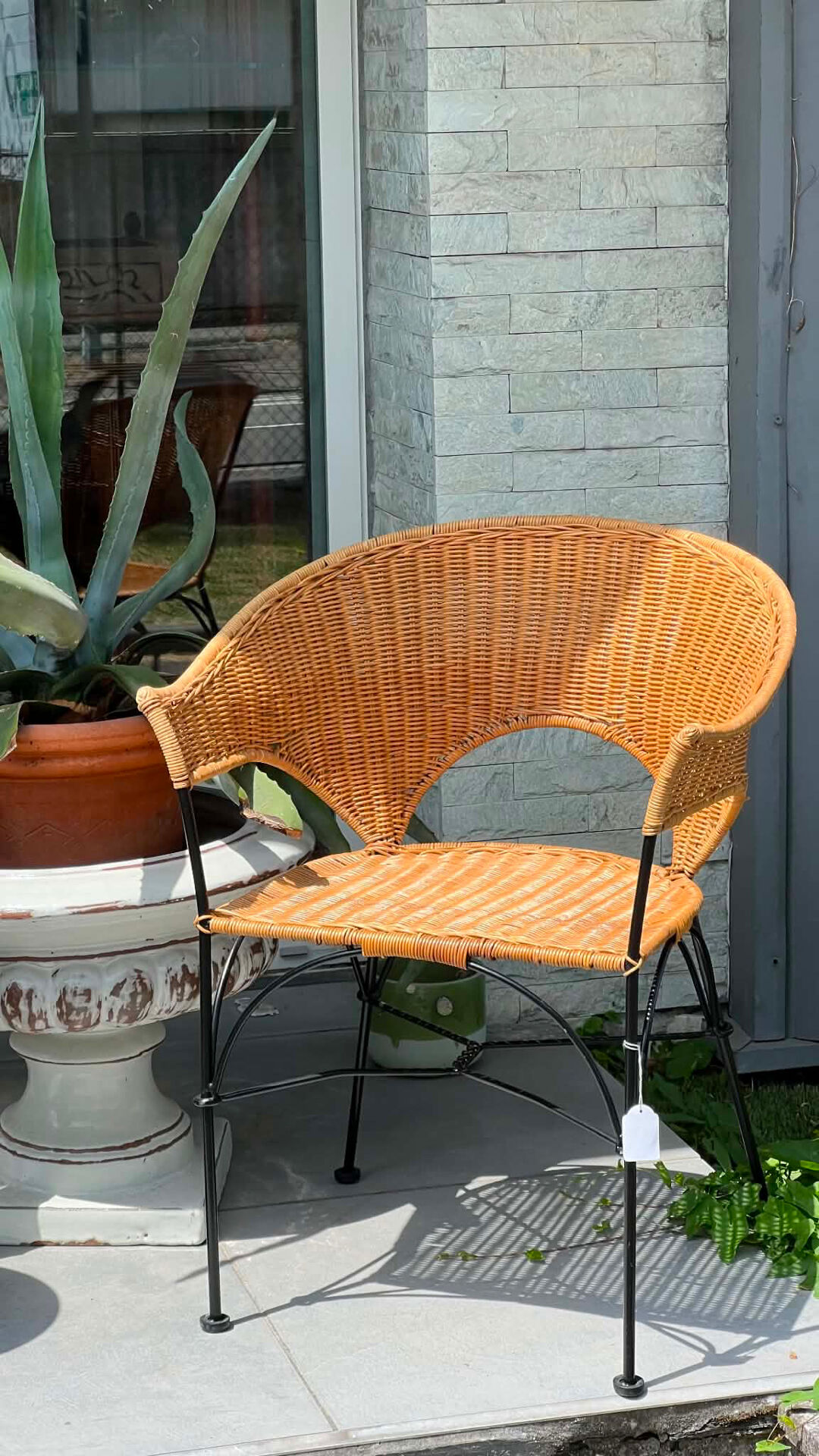 Wicker and black wrought iron armchair