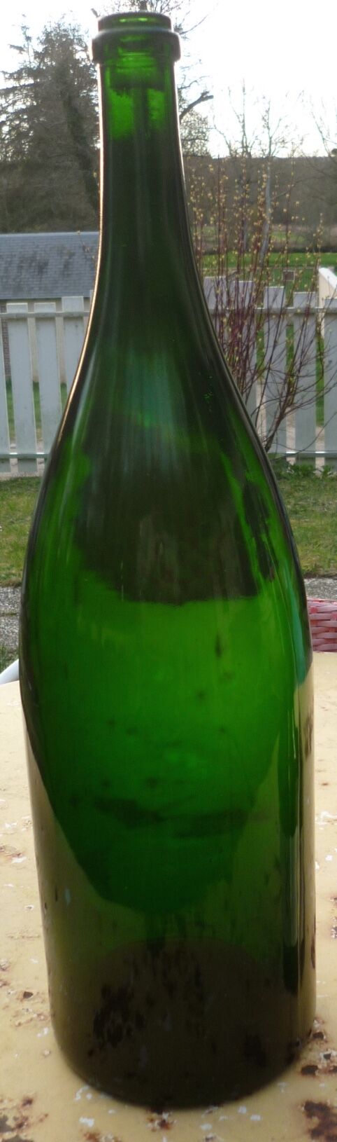 Green blown glass bottle of 58 cm.