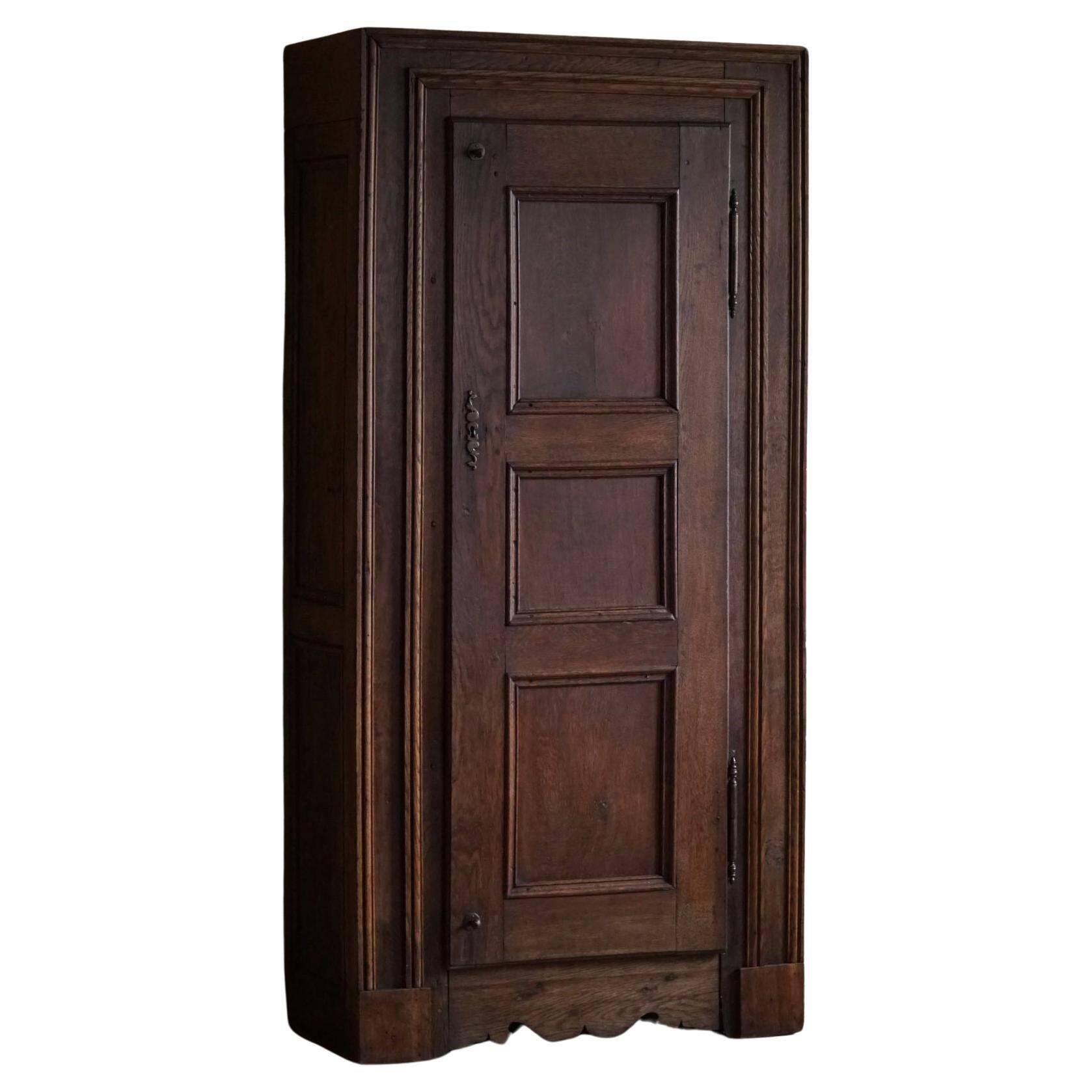 Tall antique oak wardrobe, made by a French cabinetmaker, late 19th century.