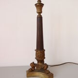 Empire period torch candle holder in bronze tripod base with lion's claws