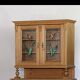 Brown pine kitchen cabinet with floral stained glass, 1920s vintage style.