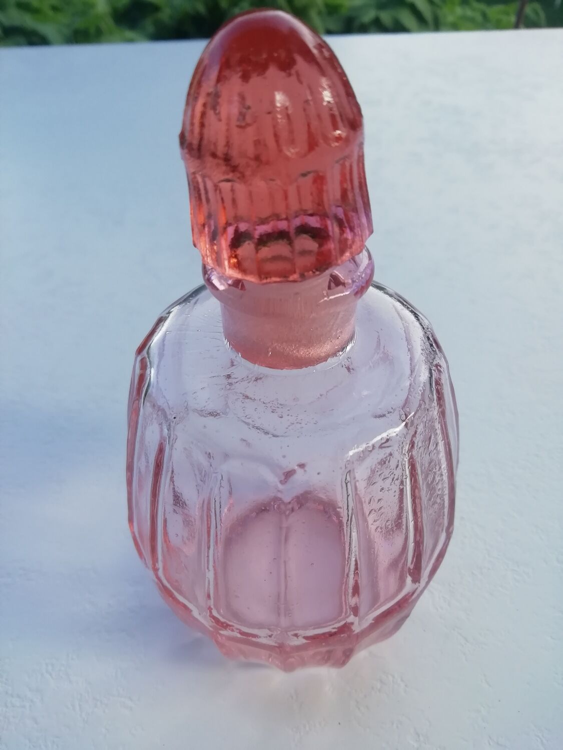 Pink molded glass bottle