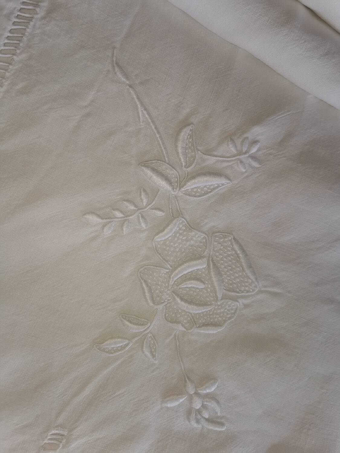 Antique embroidered linen sheet with a monogram.