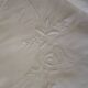 Antique embroidered linen sheet with a monogram.