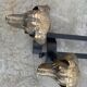 Pair of metal chenets decorated with brass dog heads