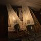Pair of antique wall sconces in brass with white ribbed glass shades.
