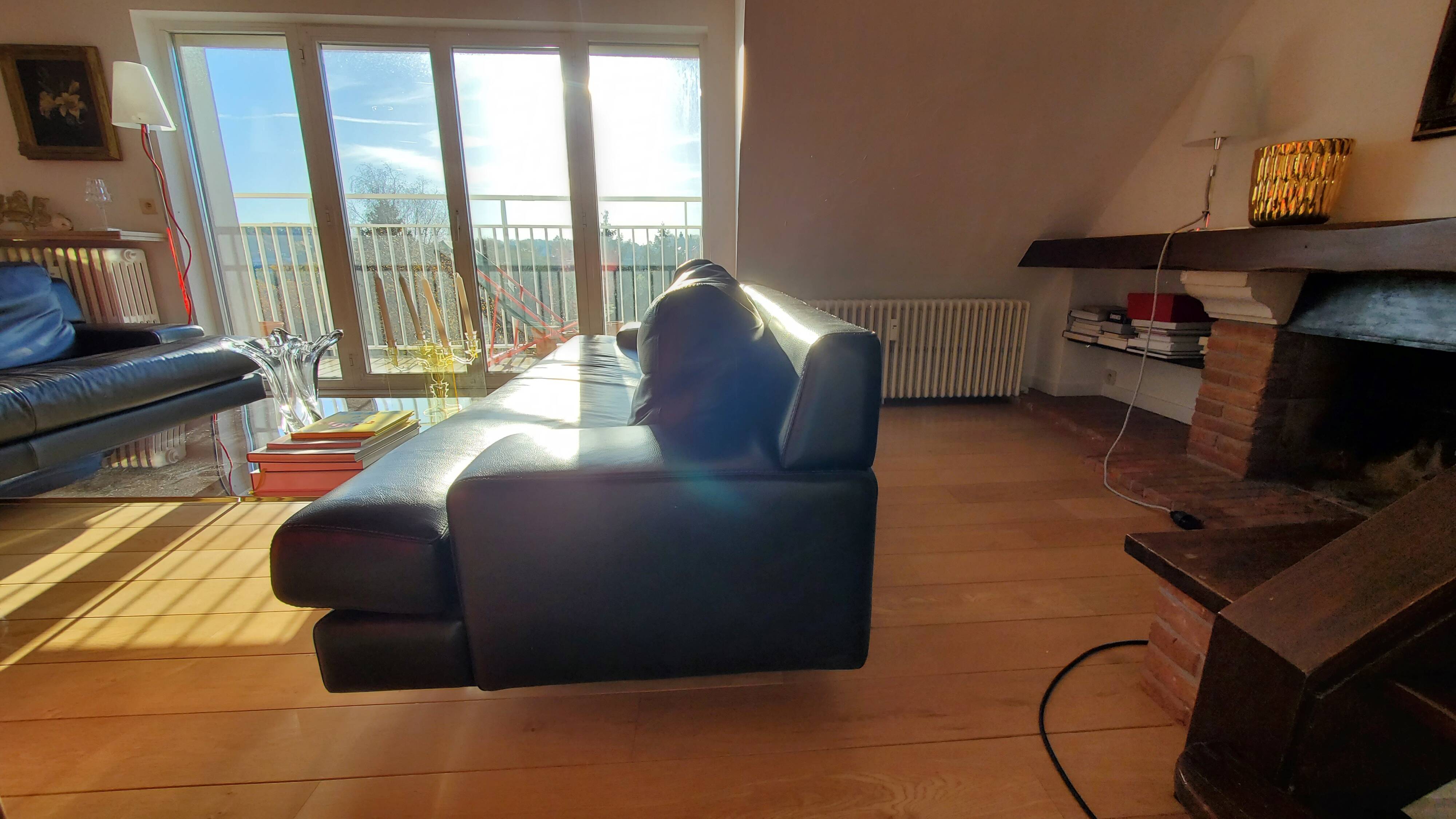 Black leather three-seater sofa