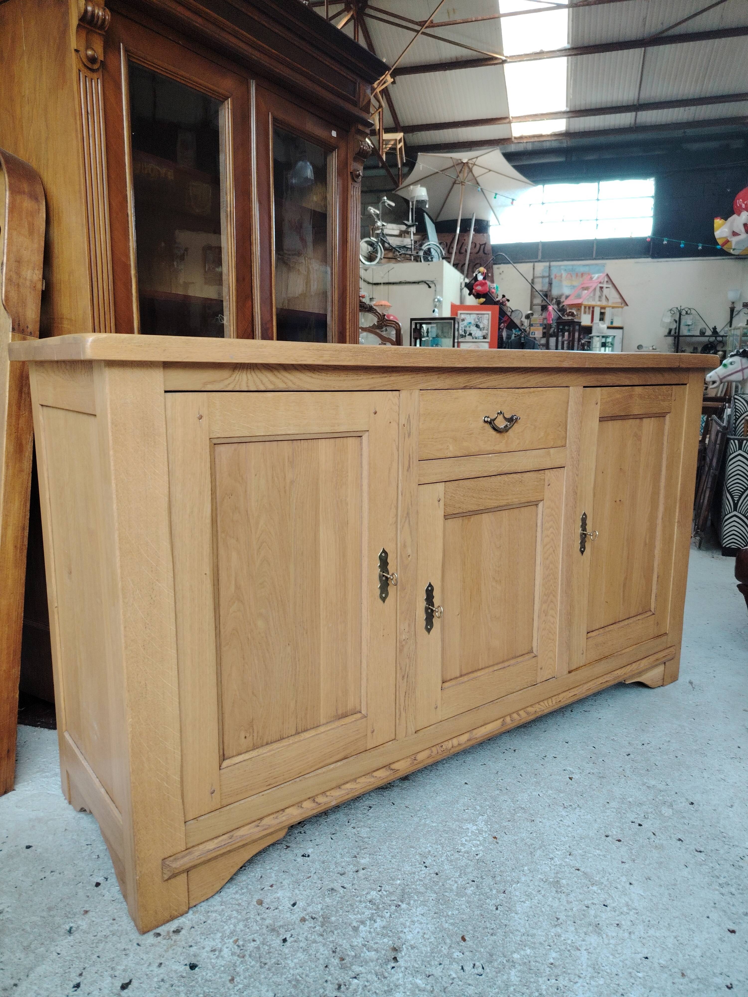 Low sideboard in light solid oak with 3 doors and 1 drawer.
