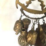 Wall decoration of brass and wood amulets