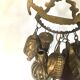Wall decoration of brass and wood amulets