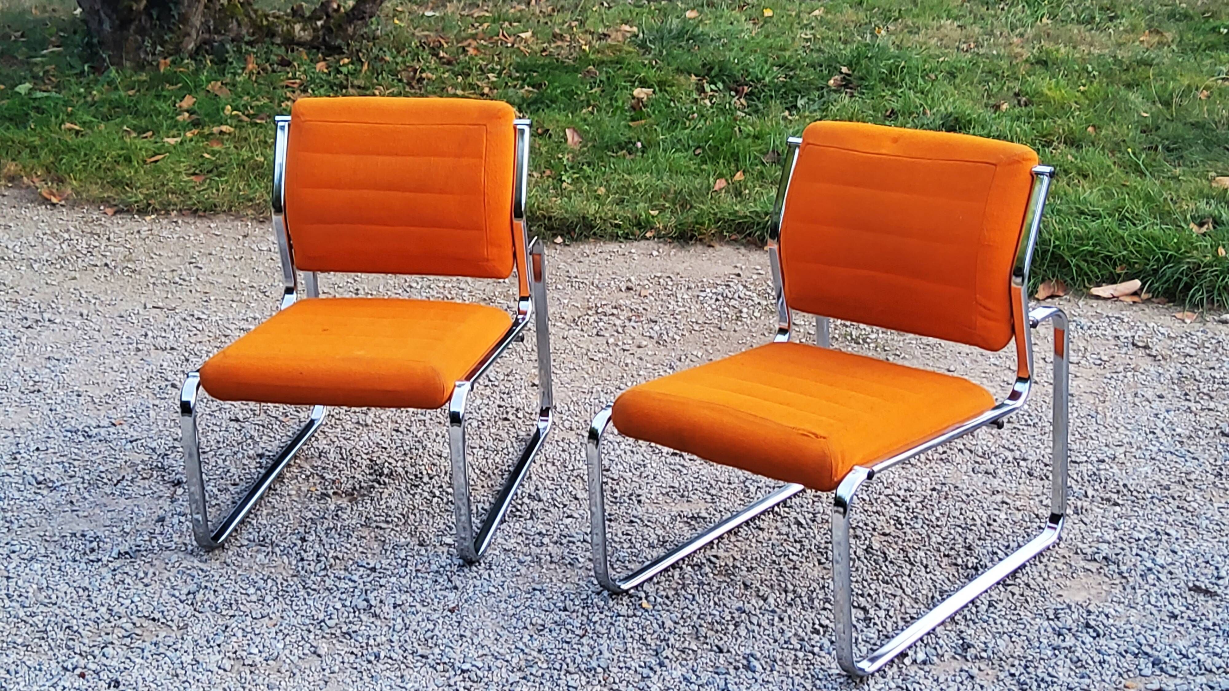 Pair of designer armchairs in orange fabrics and chrome tubes from the 70s