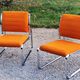 Pair of designer armchairs in orange fabrics and chrome tubes from the 70s