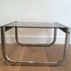 Pair of side tables in chrome, blackened wood and glass.