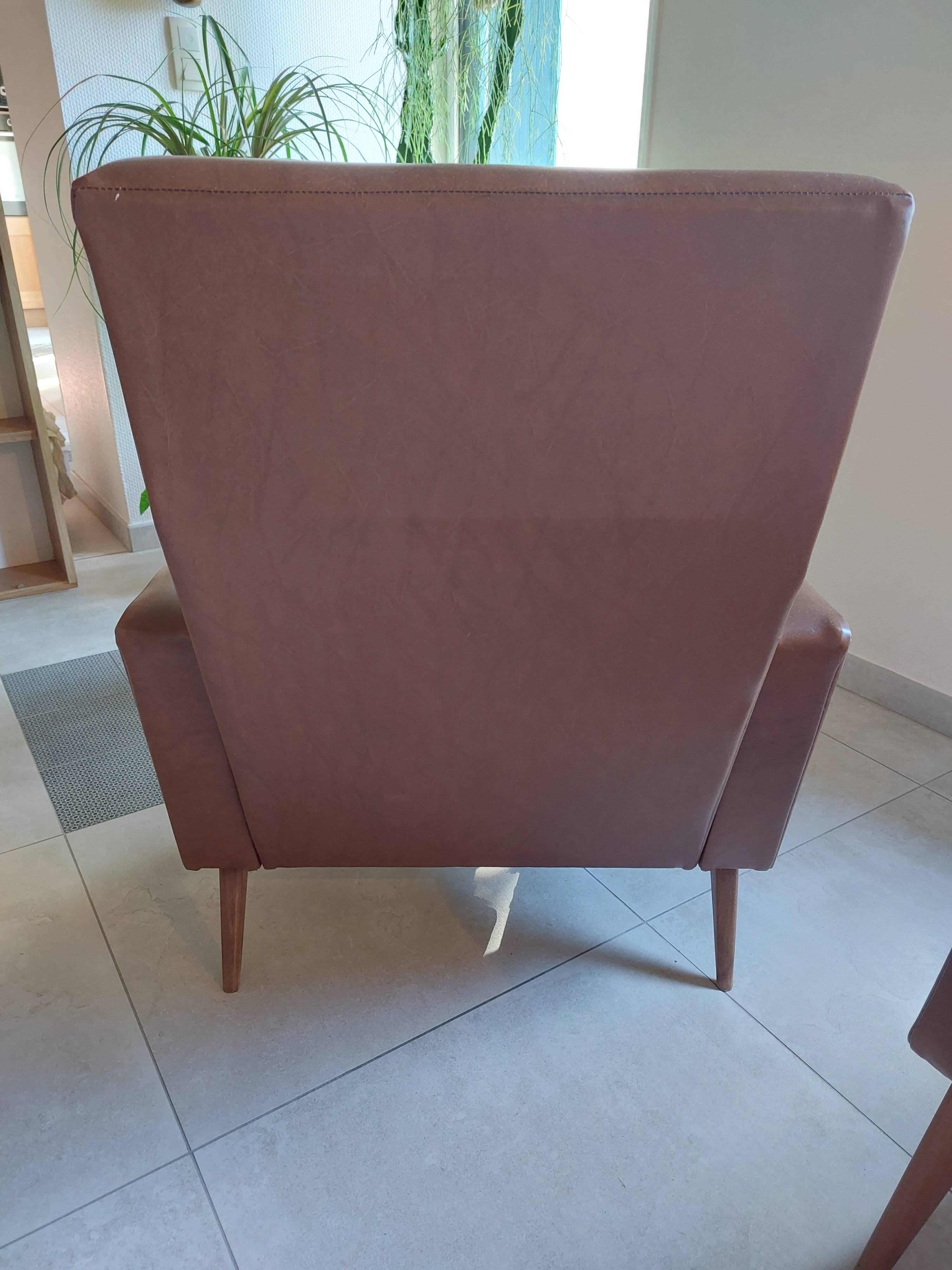 a pair of comfortable vintage armchairs with splayed legs