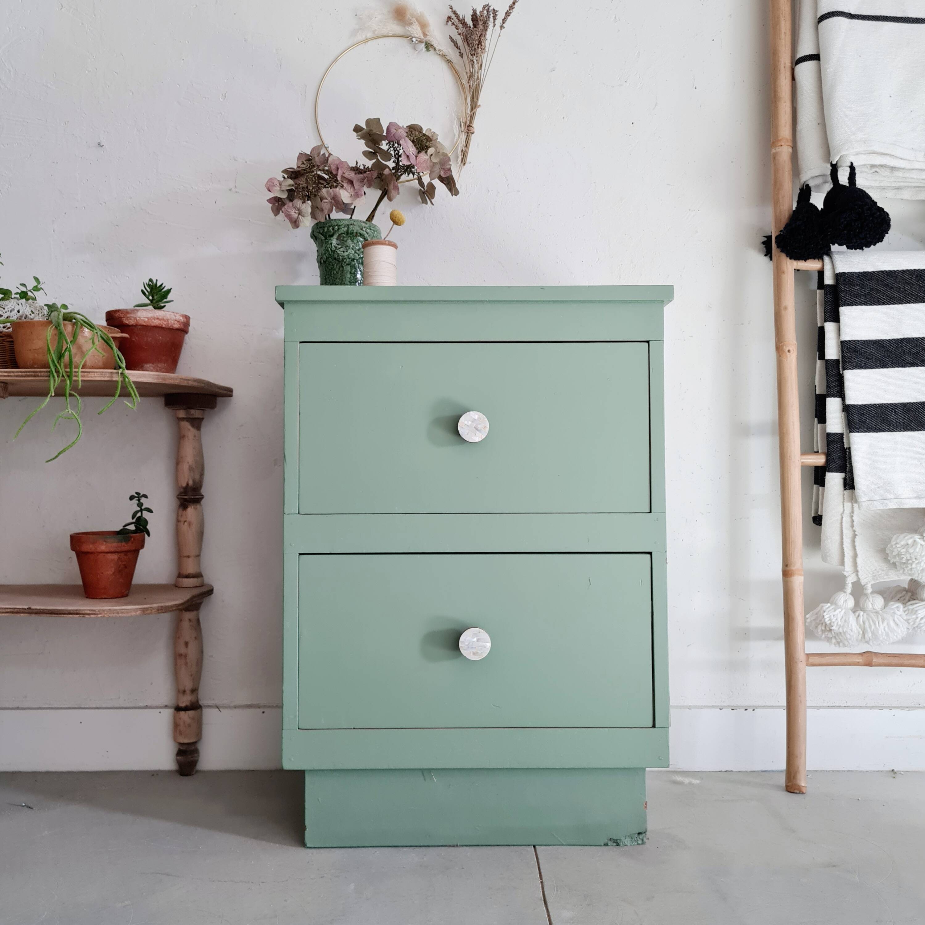 Old chest of drawers with two green drawers
