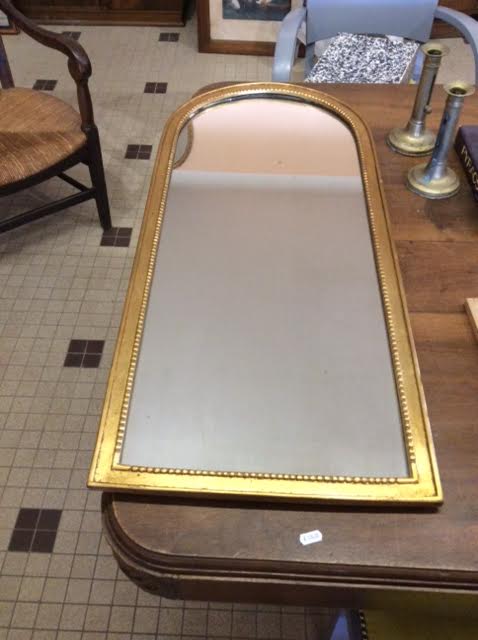 Wooden mirror and gilded stucco