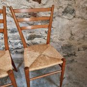 Set of 4 mid-century Italian dining chairs with woven seats, circa 1950–1970.