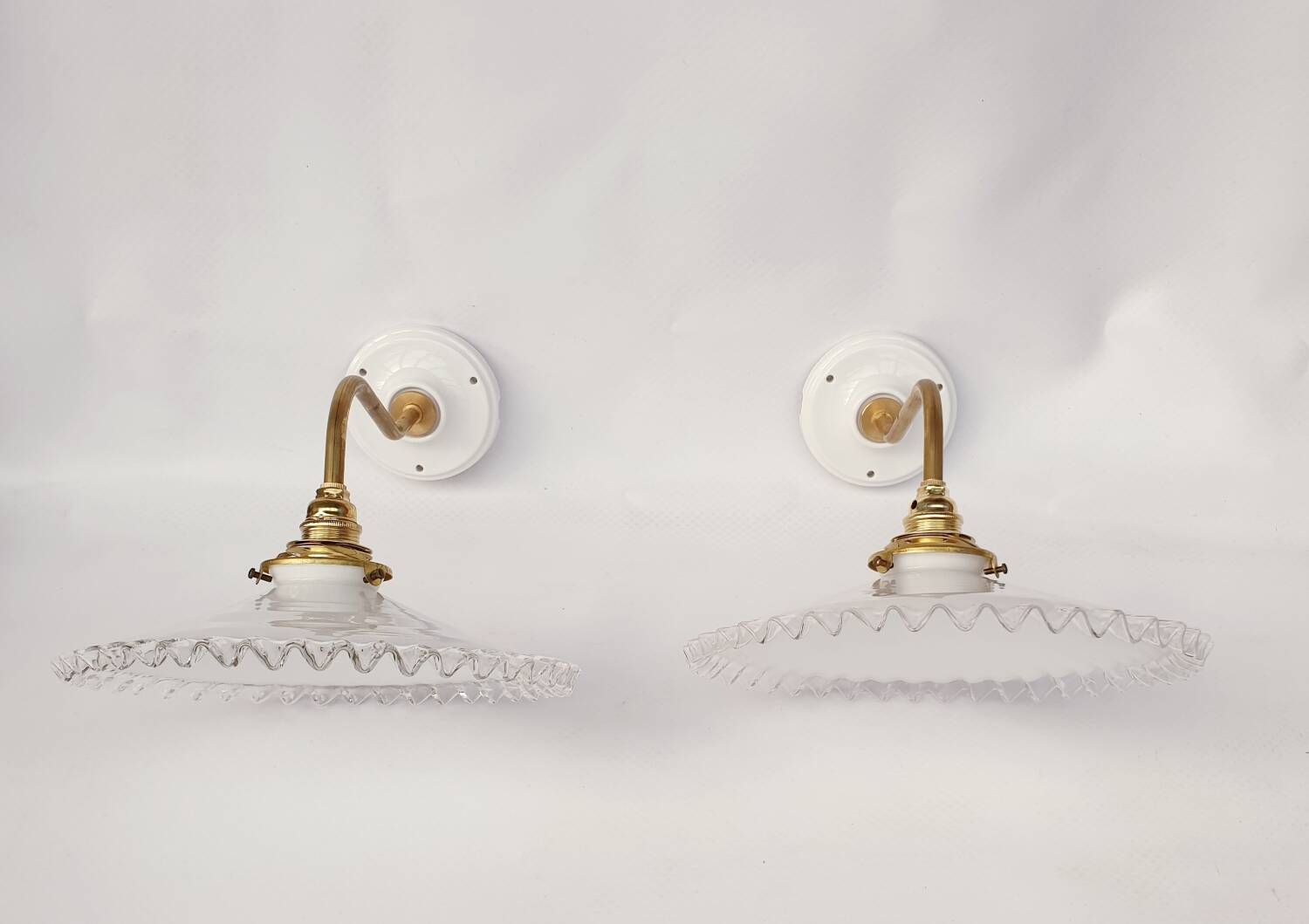 Swan neck sconces in serrated opaline
