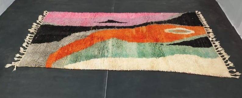 Large handmade Moroccan rug with colourful patterns.