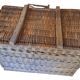 Wicker travel trunk XIX with metal clasps and handles.