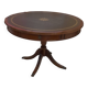 English style round table with green and gold leather top, quadripod with brass claws