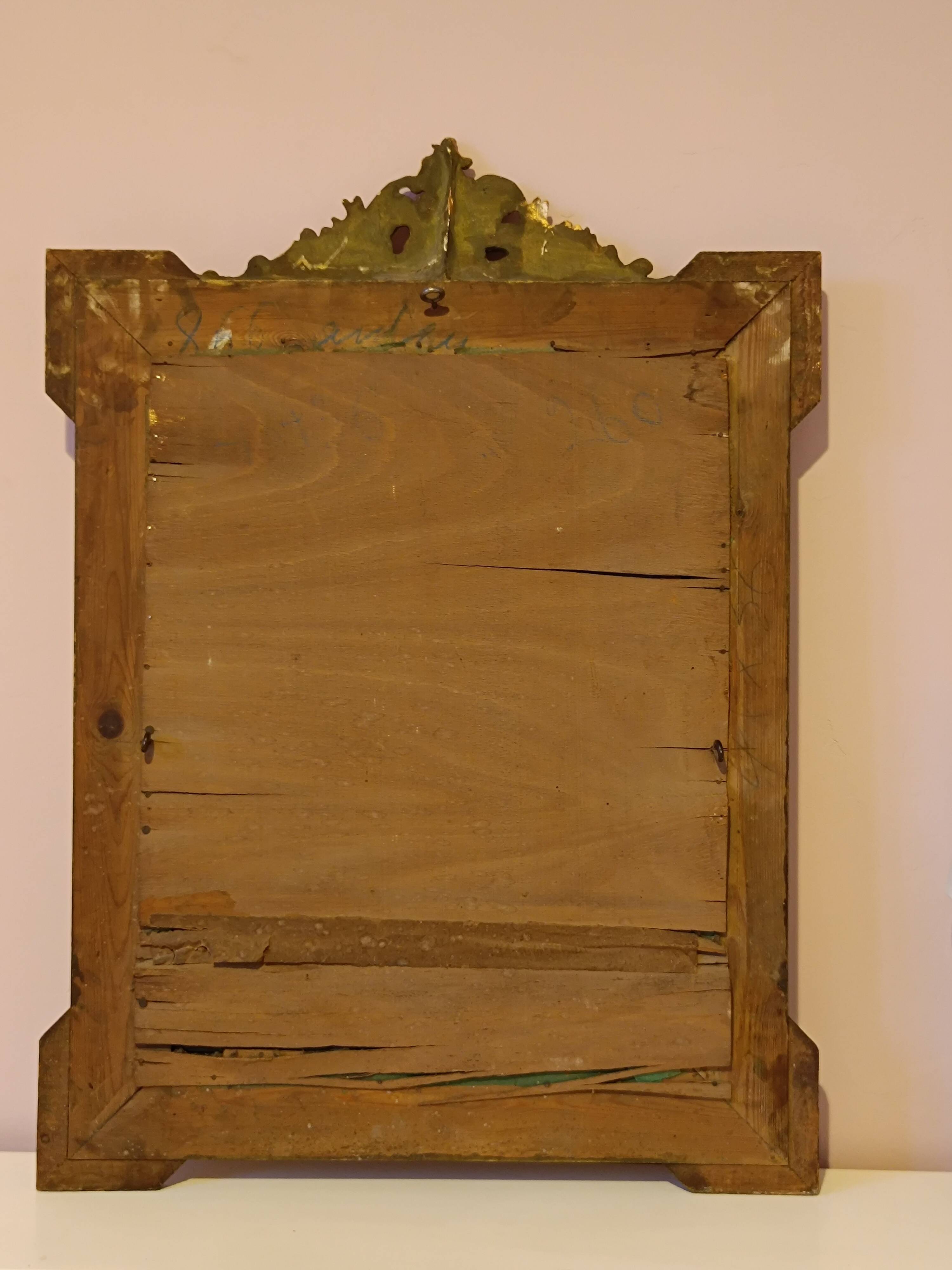 Miroir Napoléon III a riche ornementation dorée