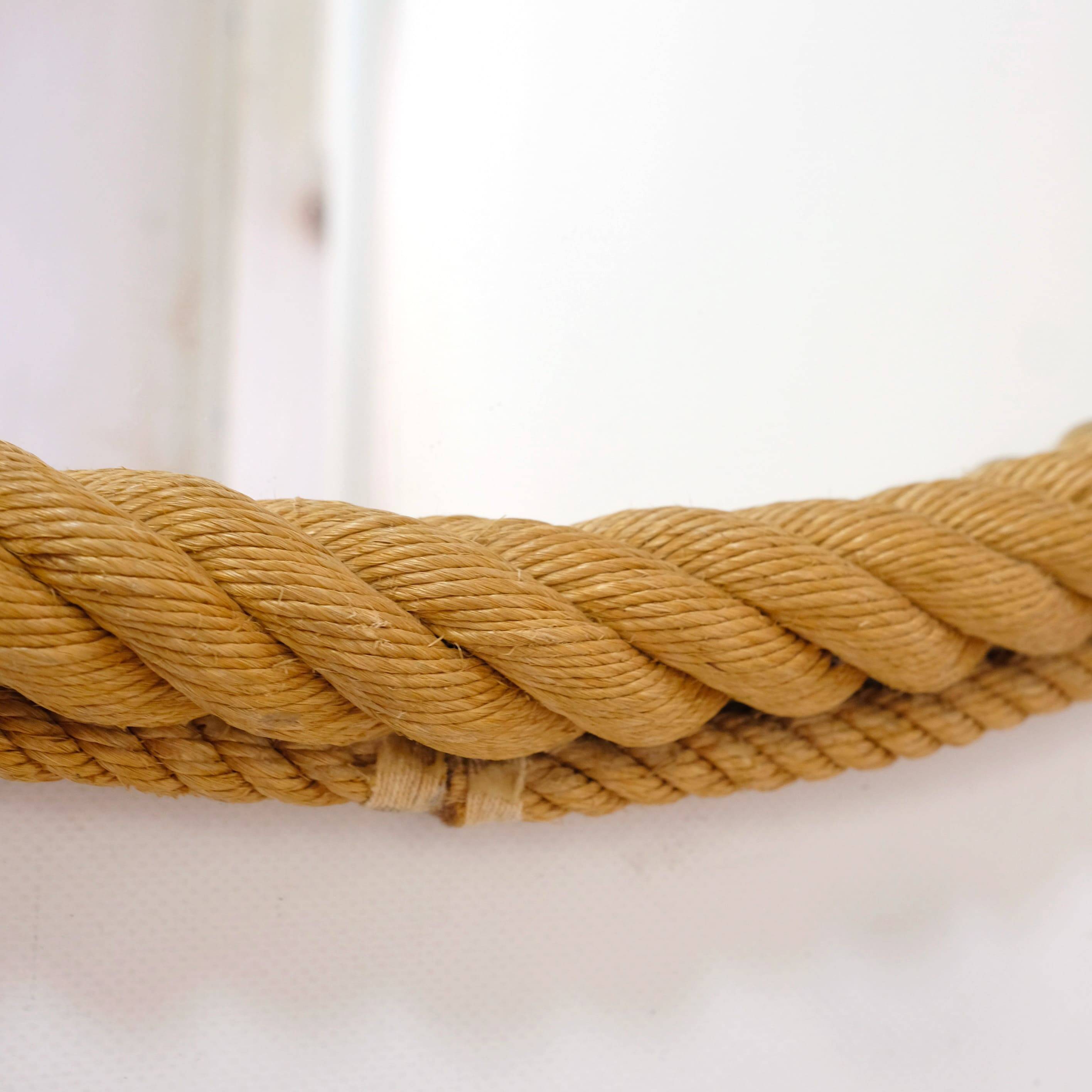 Large oval mirror in rope with pediment, 64cm x 56.5cm.