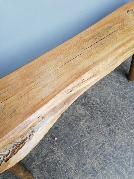 Big bench in solid rough wood very thick Brutalism
