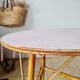 Round soft pink rattan table