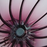 Large blown glass and wrought iron vase on shower stand