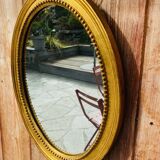 Antique gilded oval mirror