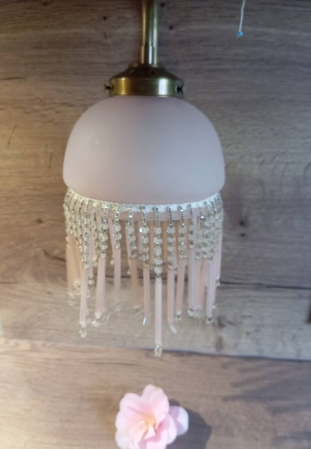 Brass swan neck wall lamp with pink glass globe and Charleston tassels