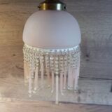 Brass swan neck wall lamp with pink glass globe and Charleston tassels