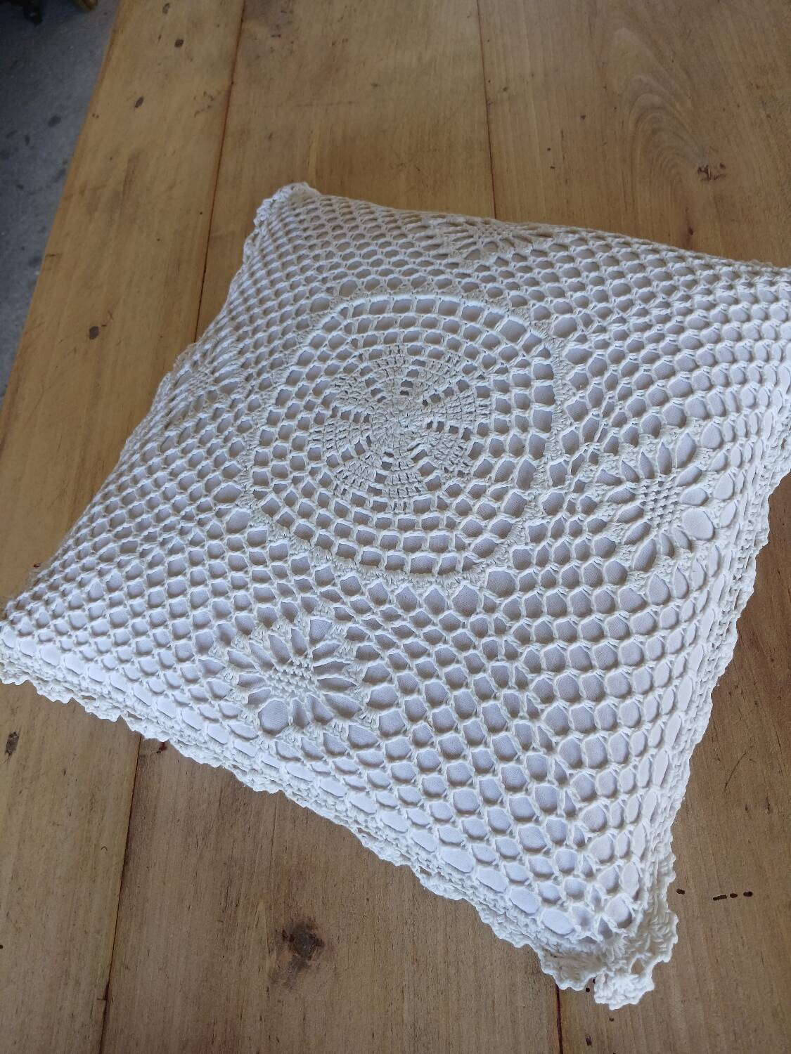 Cushion with white crochet cover